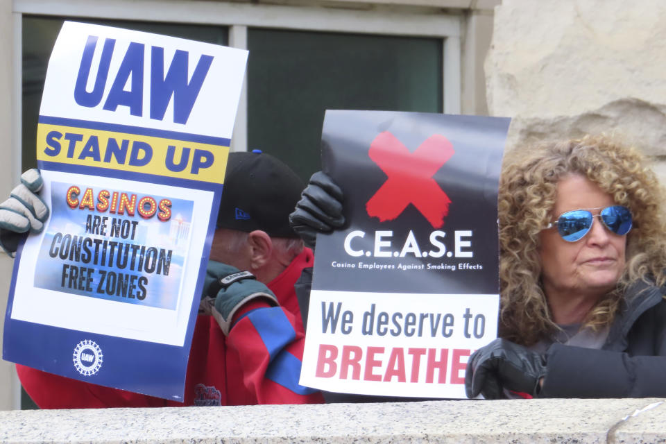 Casino workers hold signs during an anti-smoking rally in Trenton, N.J. on April 5, 2024. A national anti-smoking group and a Michigan health system are enlisting shareholders of major gambling companies including Boyd Gaming, Bally's, and Caesars Entertainment to push the companies to study the financial effects of eliminating smoking in their casinos. (AP Photo/Wayne Parry)