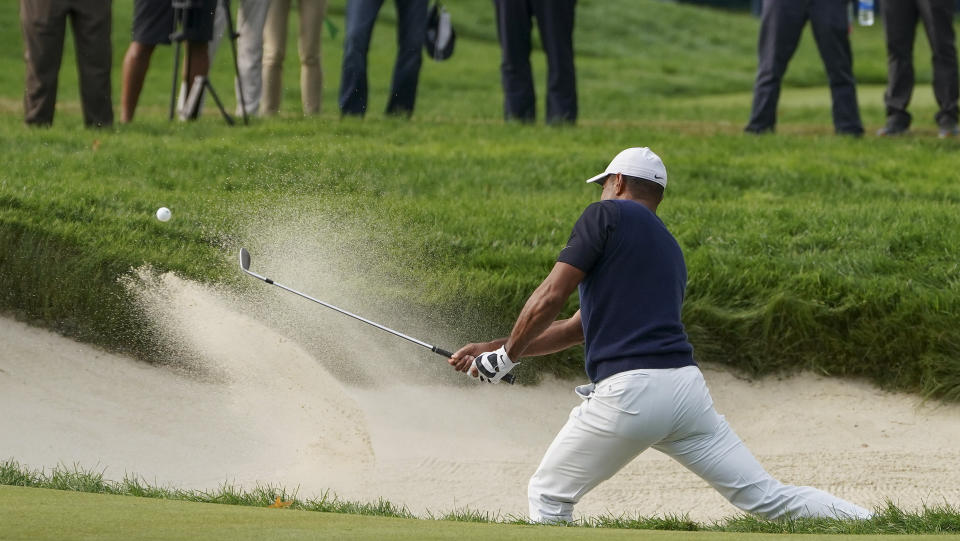 Tiger Woods, of the United States, plays a shot from a bunker on the fifth hole during the first round of the US Open Golf Championship, Thursday, Sept. 17, 2020, in Mamaroneck, N.Y. (AP Photo/John Minchillo)