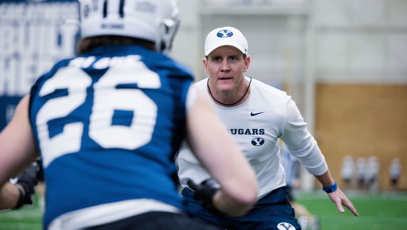 BYU defensive coordinator Jay Hill gets hands-on during spring practice at the Cougars Indoor Practice Facility in Provo. 