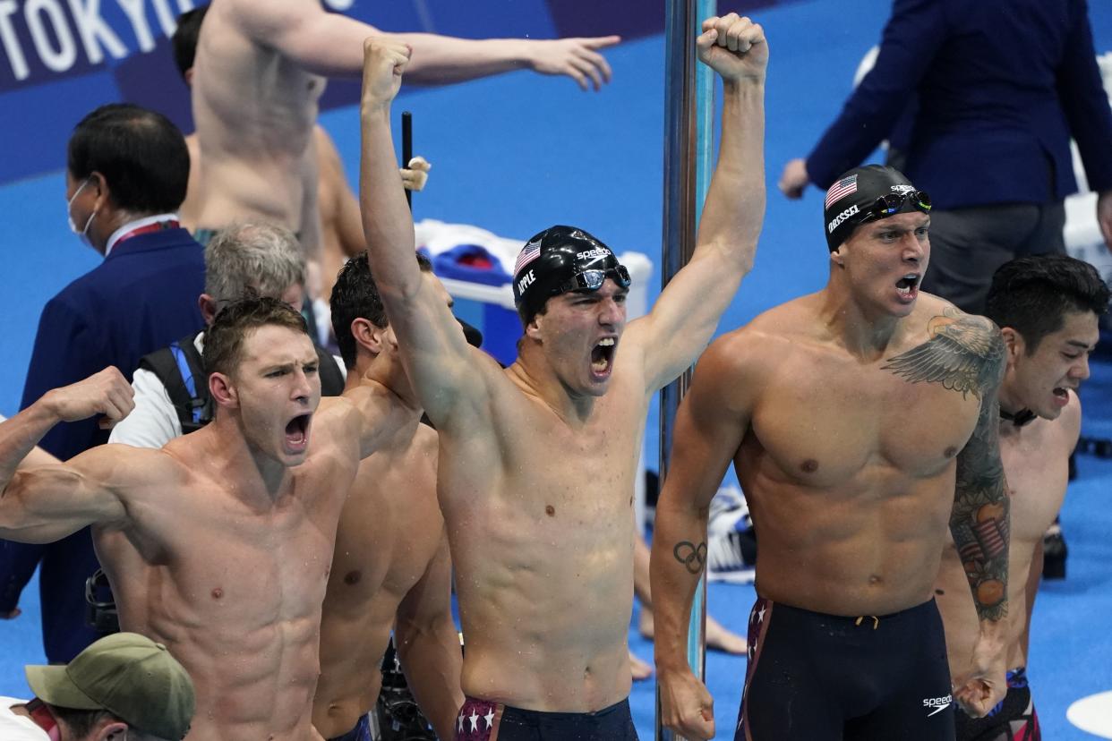 Caeleb Dressel (right) and teammates celebrate winning the gold medal in the men's 4x100-meter medley relay final at the 2020 Summer Olympics on Sunday. (AP Photo/Jae C. Hong)