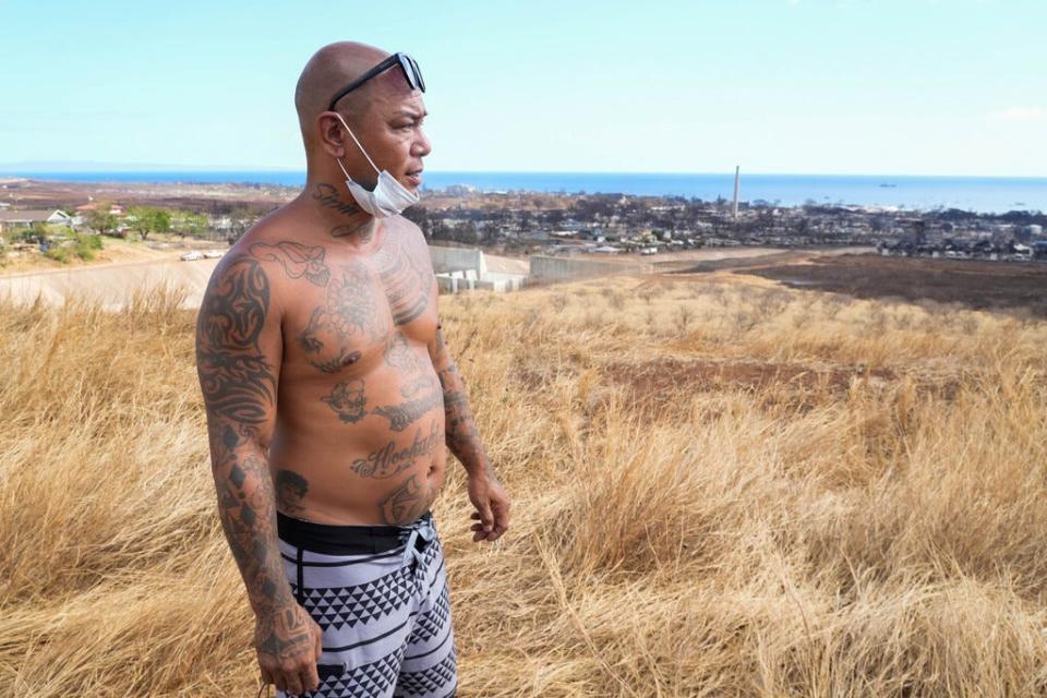 Shaun “Buge” Saribay looks over the burned buildings and homes of Lahaina. Saribay lost several homes and a business after a wildfire fueled by winds from Hurricane Dora and dry vegetation destroyed much of the town.