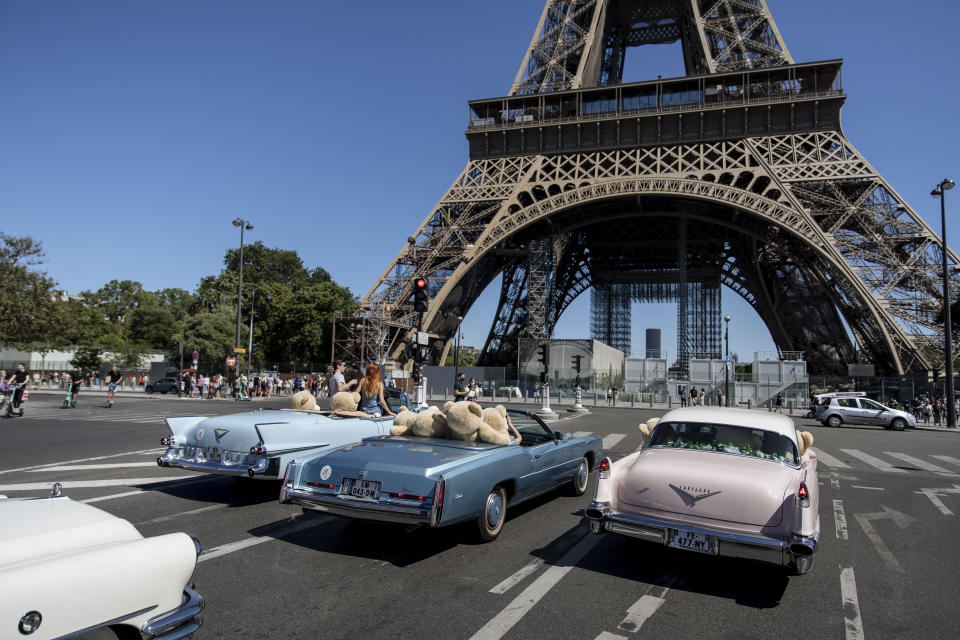 Teddy bears, set up by Philippe Labourel, who wants to be named 'Le papa des nounours' (Teddy Bears father) are pictured inside American vintage cars driving through Paris, Sunday, June, 13, 2021. The event took place in a show of support for the tourism industry which was hit by the COVID-19 pandemic. (AP Photo/Lewis Joly)