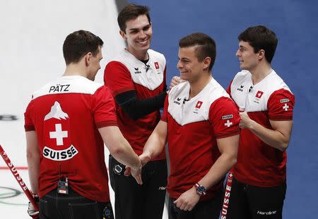 Curling - Pyeongchang 2018 Winter Olympics - Men’s Tie-Breaker - Switzerland v Britain - Gangneung Curling Center - Gangneung, South Korea - February 22, 2018 - Benoit Schwarz, Claudio Patz, Peter de Cruz and Valentin Tanner of Switzerland celebrate. REUTERS/Cathal McNaughton