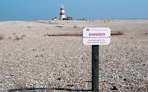 A sign at Orford Ness warns visitors of unexploded ordnance - Credit: Getty