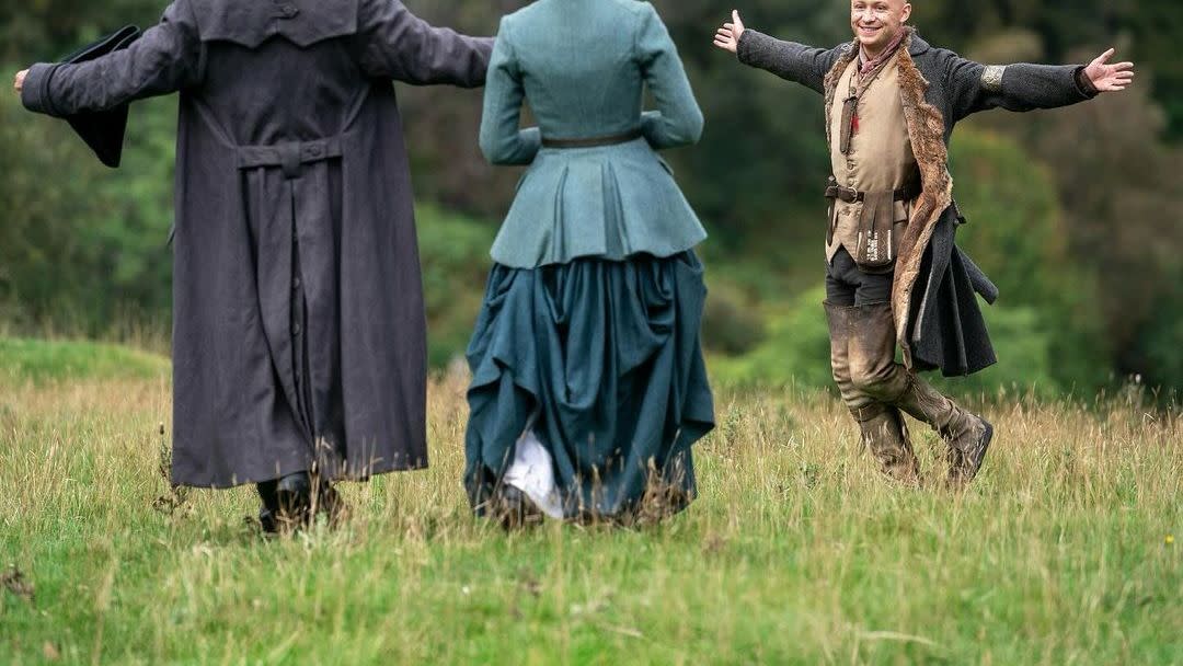 a group of people in clothing running in a field