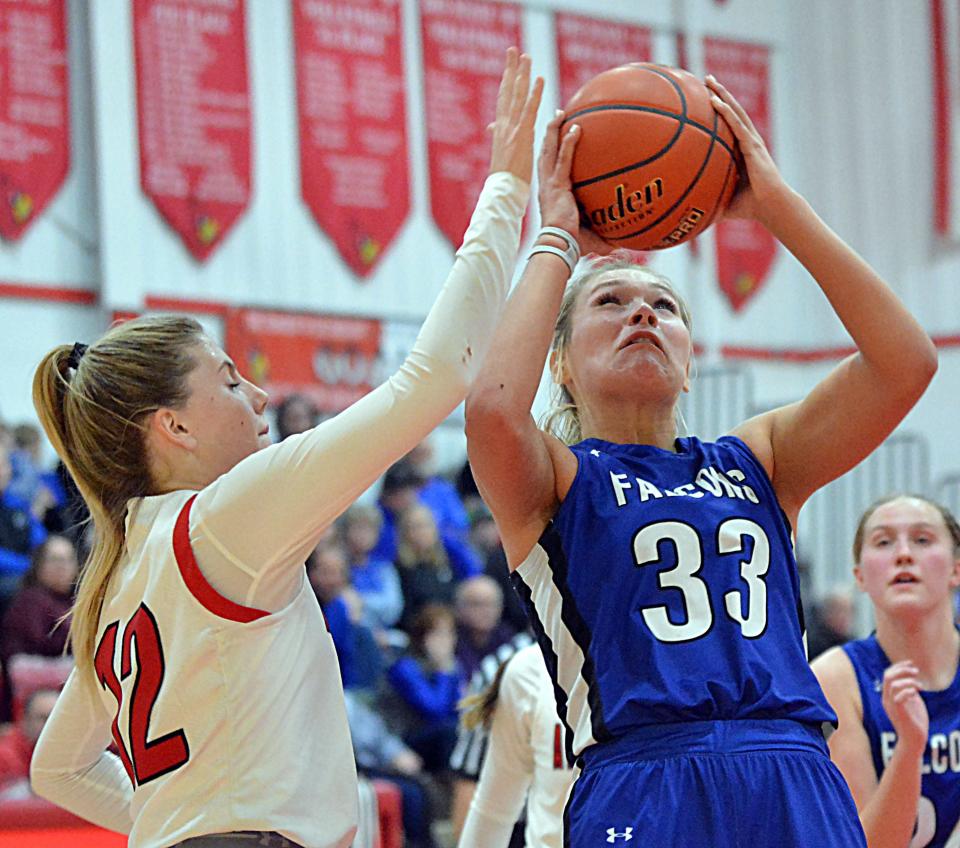 Florence-Henry's Caylin Kelly shoots against Arlington's Isabelle Steffensen during their high school girls basketball game on Tuesday, Jan. 23, 2024 in Arlington. Arlington won 51-44.