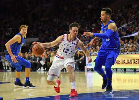 Jan 5, 2019; Philadelphia, PA, USA; Philadelphia 76ers guard T.J. McConnell (12) drives to the basket against Dallas Mavericks guard Jalen Brunson (13) during the fourth quarter at Wells Fargo Center. Mandatory Credit: Eric Hartline-USA TODAY Sports