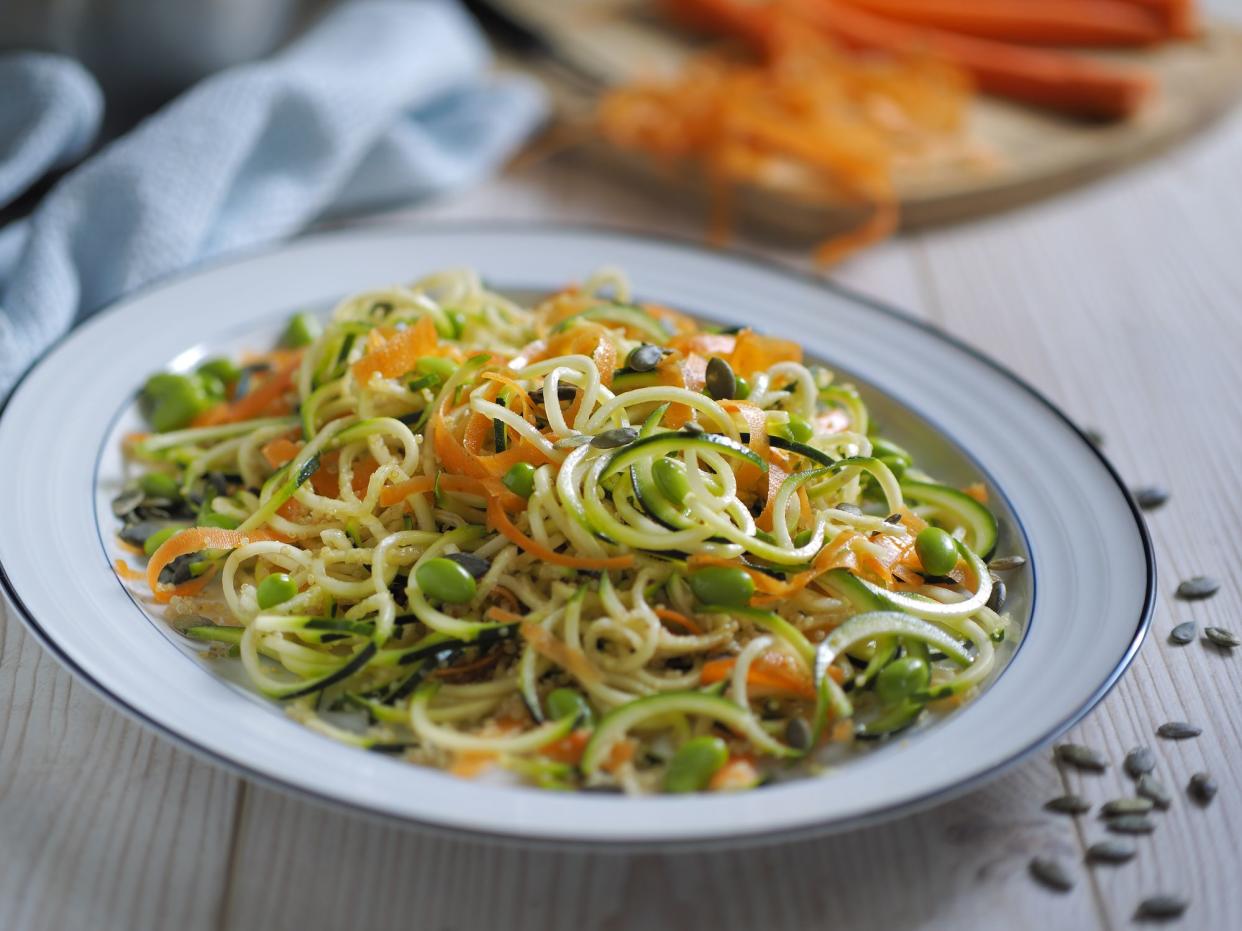 Home made frshness vegetarian noodles salad,made by courgette,carrot,and edamame beans and quiona,pumpkin seeds.