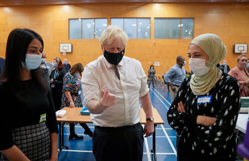 Britain's Prime Minister Boris Johnson visits a COVID-19 vaccination centre at Little Venice Sports Centre, in London