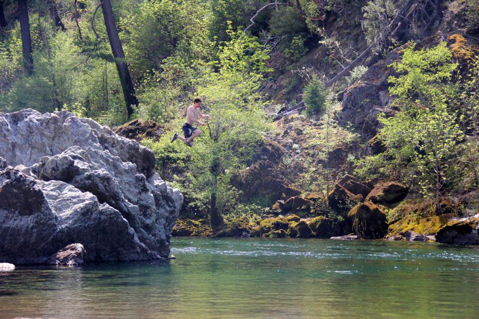 Zach Urness jumps off a rock into the deep pools of Southwest Oregon’s Illinois River in the Store Gulch Campground area of the canyon, famous for swimming holes and sandy beaches.