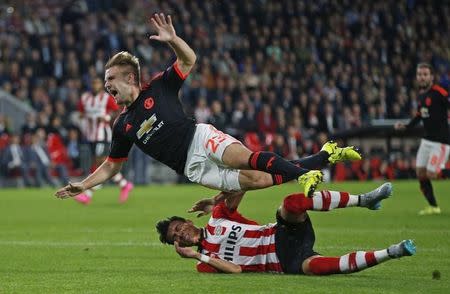 Football - PSV Eindhoven v Manchester United - UEFA Champions League Group Stage - Group B - Philips Stadion, Eindhoven, Netherlands - 15/9/15 Manchester United's Luke Shaw goes down injured after this challenge from PSV's Hector Moreno Action Images via Reuters / Andrew Couldridge Livepic