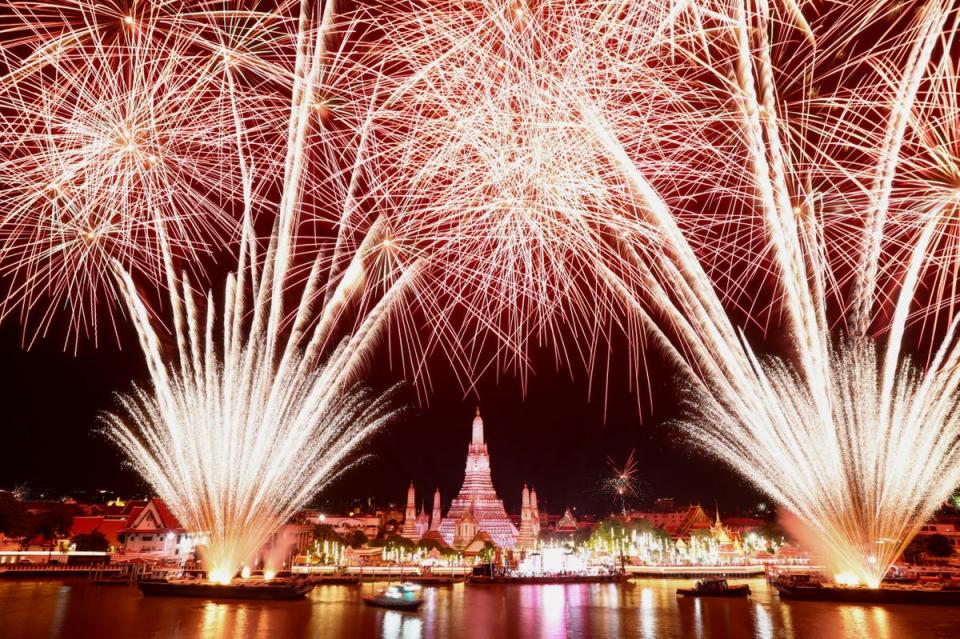 Fireworks explode over the Chao Phraya River during the New Year celebrations, in Bangkok, Thailand, (REUTERS)