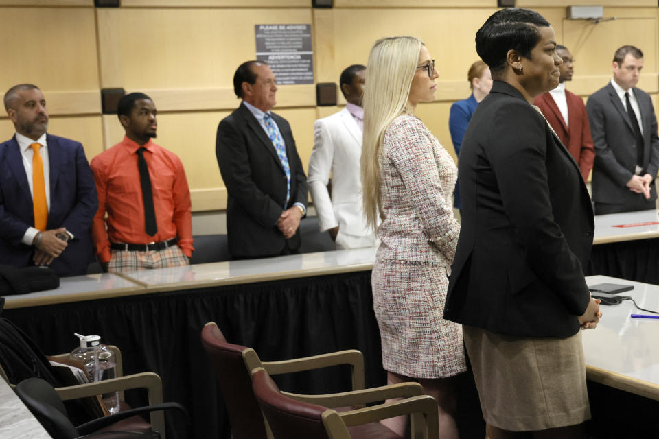 Assistant State Attorneys Pascale Achille, right, and Alixandra Buckelew stand along with the defendants and their attorneys as the jury enters the courtroom to report for the fourth day of jury deliberations in the XXXTentacion murder trial at the Broward County Courthouse in Fort Lauderdale on Monday, March 13, 2023. Emerging rapper XXXTentacion, born Jahseh Onfroy, 20, was killed during a robbery outside of Riva Motorsports in Deerfield Beach in 2018 allegedly by defendants Michael Boatwright, Trayvon Newsome, and Dedrick Williams. (Amy Beth Bennett/South Florida Sun-Sentinel via AP, Pool)