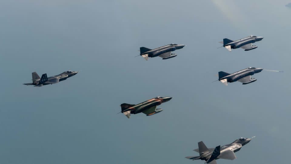 South Korean Air Force F-4s flying in formation with two KF-21 fighter jet prototypes over southern South Korea on May 8, 2024. - South Korean Air Force