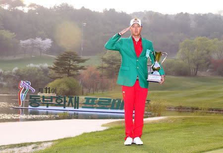 Hur In-hoe salutes as he pose for photographs after won a golf tournament in Pocheon, South Korea, in this handout picture provided by KPGA and released by News1 on April 26, 2015. REUTERS/KPGA/News1