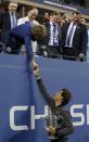 Rafael Nadal of Spain holds his trophy as he shakes hands with Queen Sofia of Spain after defeating Novak Djokovic of Serbia in their men's final match at the U.S. Open tennis championships in New York, September 9, 2013.