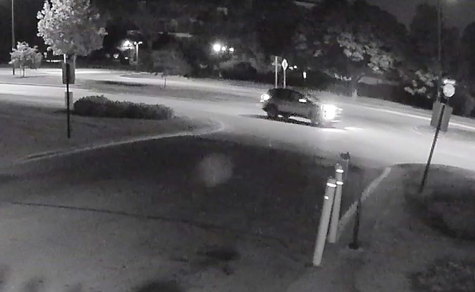 In the video, footage shows a lights from a vehicle traveling Southbound on Providence Drive. As the vehicle nears the entrance of an apartment driveway, it slows down from the speed it was initially going in before accelerating past the gated entranceway.