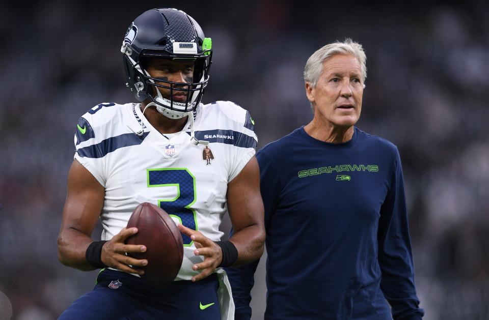 Russell Wilson and Pete Carroll before a preseason game in August 2021.