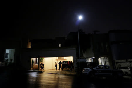 A police car is parked outside the home of a teenage student who shot several students and a teacher at the private school Colegio Americano del Noreste before killing himself, in Monterrey, Mexico, January 18, 2017. REUTERS/Daniel Becerril