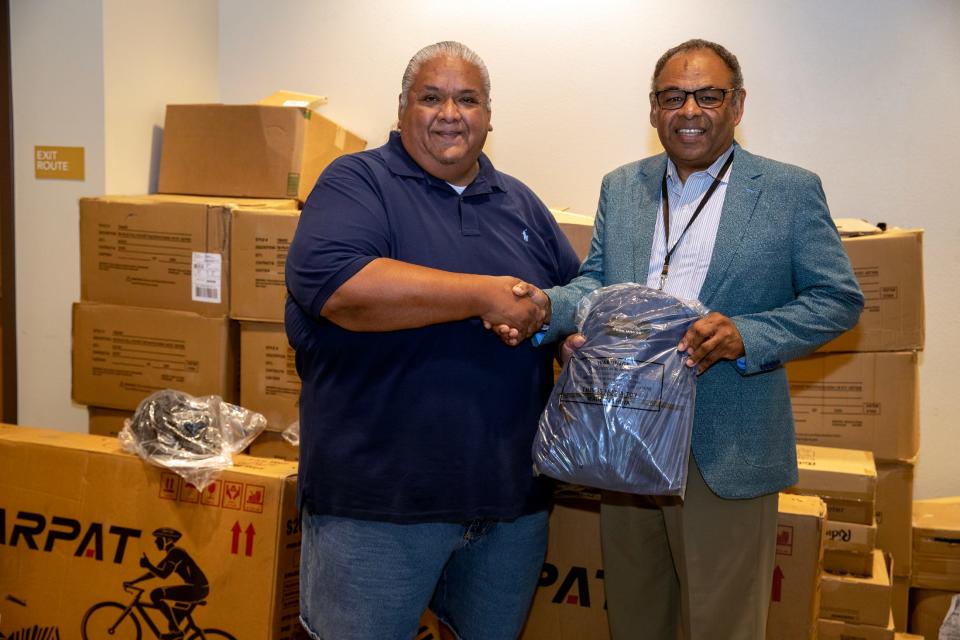 Chairman Darrell Mike of the Twenty-Nine Palms Band of Mission Indians shakes hands with Coachella Valley Unified School District Superintendent Luis Valentino after dropping off donated new backpacks and school supplies at the district offices in Thermal, Calif., on August 11, 2023.