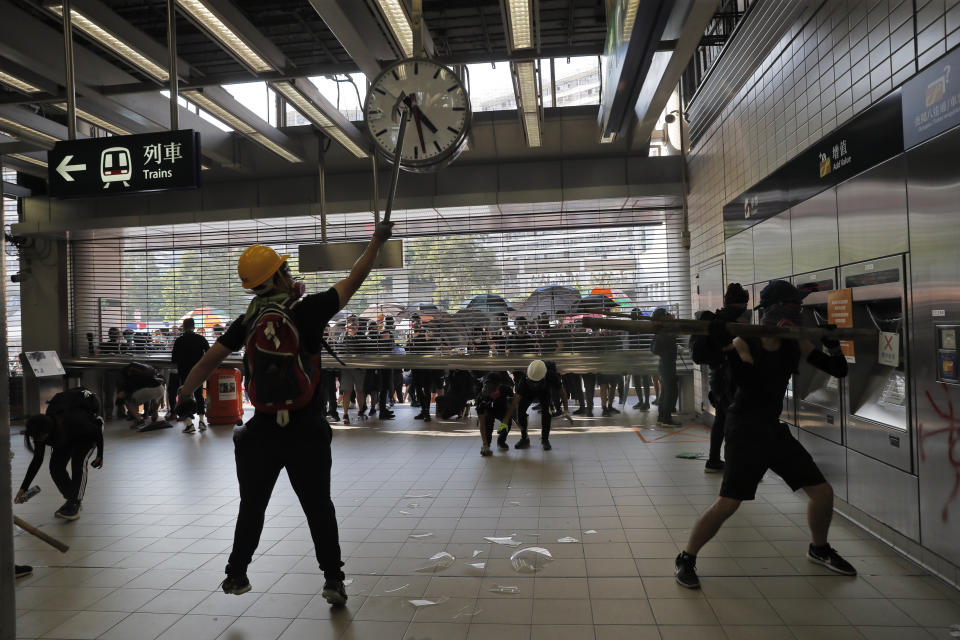 Anti-government protesters vandalize a MTR public transport station in Hong Kong, Oct. 1, 2019. In a fearsome escalation of violence, Hong Kong police shot a protester at close range in the chest Tuesday, leaving the teenager bleeding and howling on the ground. (Photo: Kin Cheung/AP)