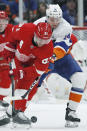 Detroit Red Wings center Frans Nielsen (81) and New York Islanders right wing Tom Kuhnhackl (14) go after the puck during the first period of an NHL hockey game Friday, Feb. 21, 2020, in Uniondale, N.Y. (AP Photo/Kathy Willens)