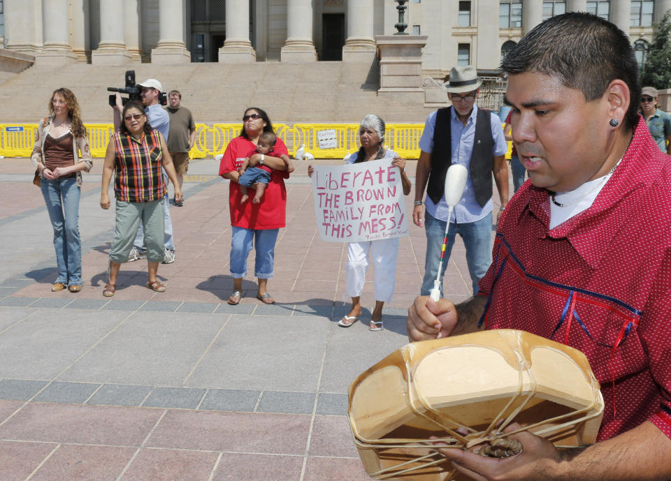 FILE - Chebon Kernell beats a drum and sings during a rally in support of three-year-old baby Veronica, Veronica's biological father, Dusten Brown, and the Indian Child Welfare Act, in Oklahoma City, Monday, Aug. 19, 2013. Brown is trying to maintain custody of the girl who was given up for adoption by her birth mother to a couple in South Carolina. The U.S. Supreme Court will hear arguments, Wednesday, Nov. 9, 2022 on the most significant challenge to the Indian Child Welfare Act that gives preference to Native American families in foster care and adoption proceedings of Native American children since it passed in 1978. (AP Photo/Sue Ogrocki, File)