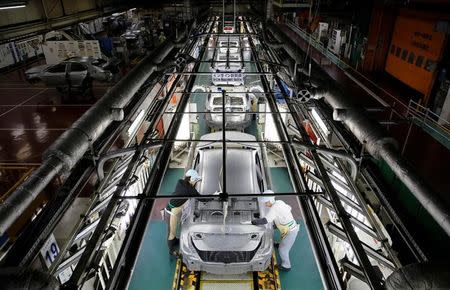 Employees work on an assembly line of the Toyota Motor Corp's Prius hybrid car at the Tsutsumi plant in Toyota, central Japan, December 8, 2017. REUTERS/Toru Hanai