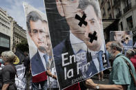 Demonstrators hold posters showing French Interior Minister Gerald Darmanin during a demonstration, Saturday, June 12, 2021 in Paris. Thousands of people rallied throughout France Saturday to protest against the far-right. (AP Photo/Lewis Joly)