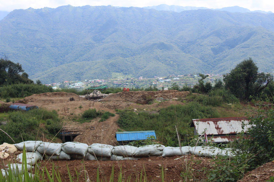 Lookout from a Chinland Defense Forces-Thantlang camp onto the town of Thantlang, where Myanmar military forces have committed more than 2 dozen arson attacks since September 2021, destroying more than 1,200 buildings and displacing all of its 10,000 residents. Today, the town remains a frontline of the fight for control over the township.<span class="copyright">Emily Fishbein</span>