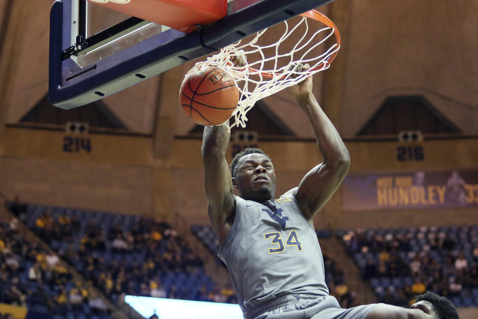 West Virginia forward Oscar Tshiebwe (34) dunks during the second half of the team's NCAA college basketball game against TCU on Tuesday, Jan. 14, 2020, in Morgantown, W.Va. (AP Photo/Kathleen Batten)