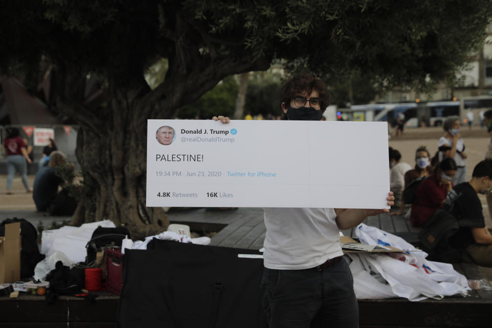 People take part in a protest against Israel's plan to annex parts of the West Bank and Trump's mideast initiative, in Tel Aviv, Israel, Tuesday, June 23, 2020. (AP Photo/Sebastian Scheiner)