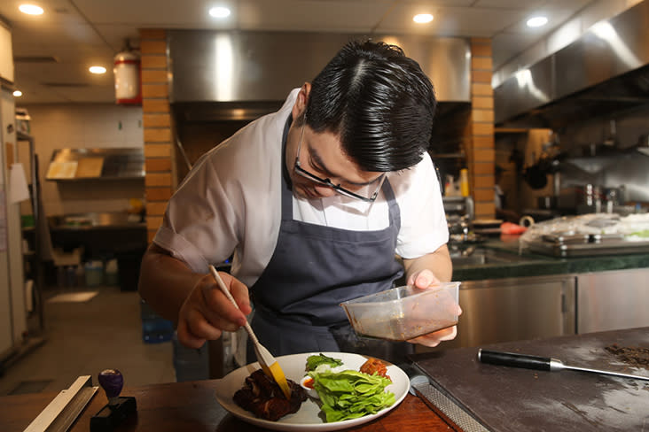 Kelvin Wong, who once worked at Rockpool with Neil Perry in Australia, brushes the caramel based sauce over the crispy pork belly.