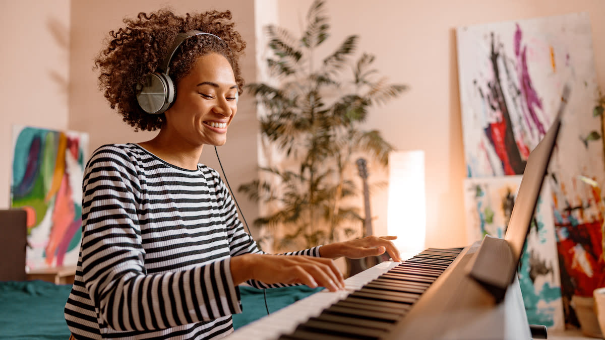  Smiling woman playing piano 