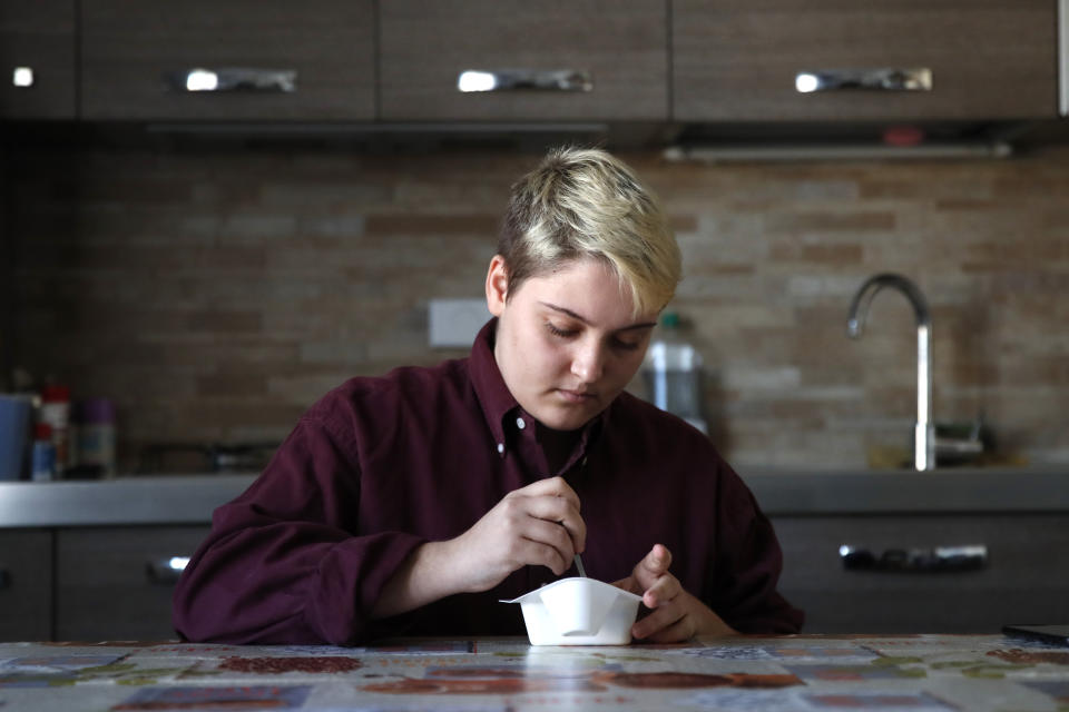 Matteo Coccimiglio eats his breakfast in Rome, Thursday, March 18, 2021. Matteo is an 18-year-old student who identifies as a man and is in the process of changing his legal gender from female to male. The Ripetta school of art in Rome - where he studies - recently joined a handful of high schools in Italy that give transgender students the right to be known by a name other than the one they were given at birth. The initiative is meant to create an environment where transgender students feel secure and reflects a growing awareness in Italy of gender dysphoria among teenagers and children. (AP Photo/Alessandra Tarantino)