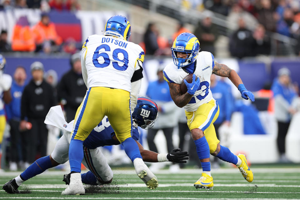 Dec 31, 2023; East Rutherford, New Jersey, USA; Los Angeles Rams running back Kyren Williams (23) scores a rushing touchdown as Los Angeles Rams guard Kevin Dotson (69) blocks New York Giants linebacker Bobby Okereke (58) during the second half at MetLife Stadium. Mandatory Credit: Vincent Carchietta-USA TODAY Sports