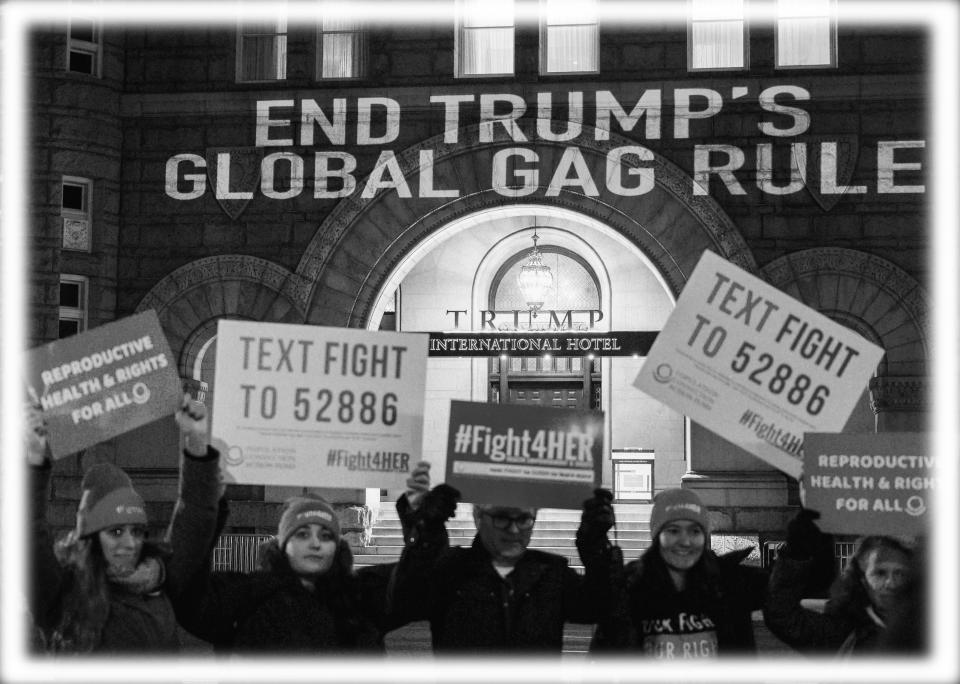 Activists hold signs as they project a message onto the Trump International Hotel, to protest the Global Gag Rule which bans health care providers that receive US global health aid from referring, providing or discussing abortion with their patients, during a demonstration in Washington, DC on January 23, 2019. (Photo: Andrew Caballero-Reynolds/AFP/Getty Images; digitally enhanced by Yahoo News)