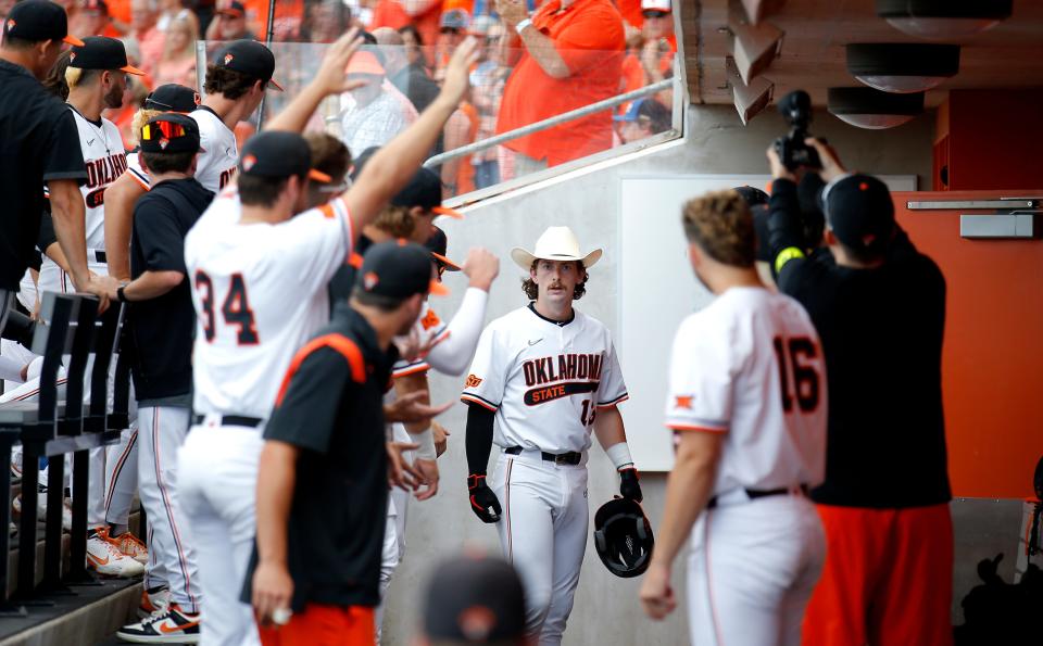 Oklahoma State's Nolan McLean (13) gets ready to celebrate a home run in the fourth inning during the NCAA Stillwater Regional baseball game between Oklahoma State Cowboys and Missouri State Bears at the O'Brate Stadium in Stillwater, Okla., Friday, June, 3, 2022. 