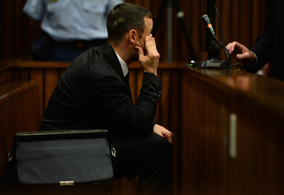Oscar Pistorius sits in the dock in court in Pretoria, South Africa, Friday, March 14, 2014 on the tenth day of his murder trial proceedings. Pistorius is charged with the shooting death of his girlfriend Reeva Steenkamp, on Valentines Day in 2013. (AP Photo/Phill Magakoe, Pool)