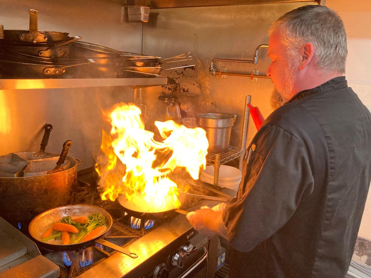 Jesse Willis, chef at the North Hero House, works the stove Oct. 20, 2023.