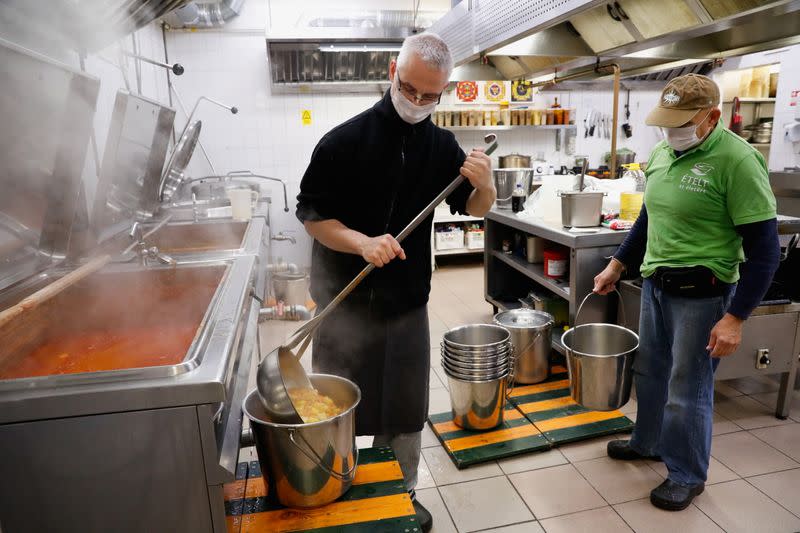 A member of Food for Life Foundation prepares food to distribute for free to poor people in Budapest