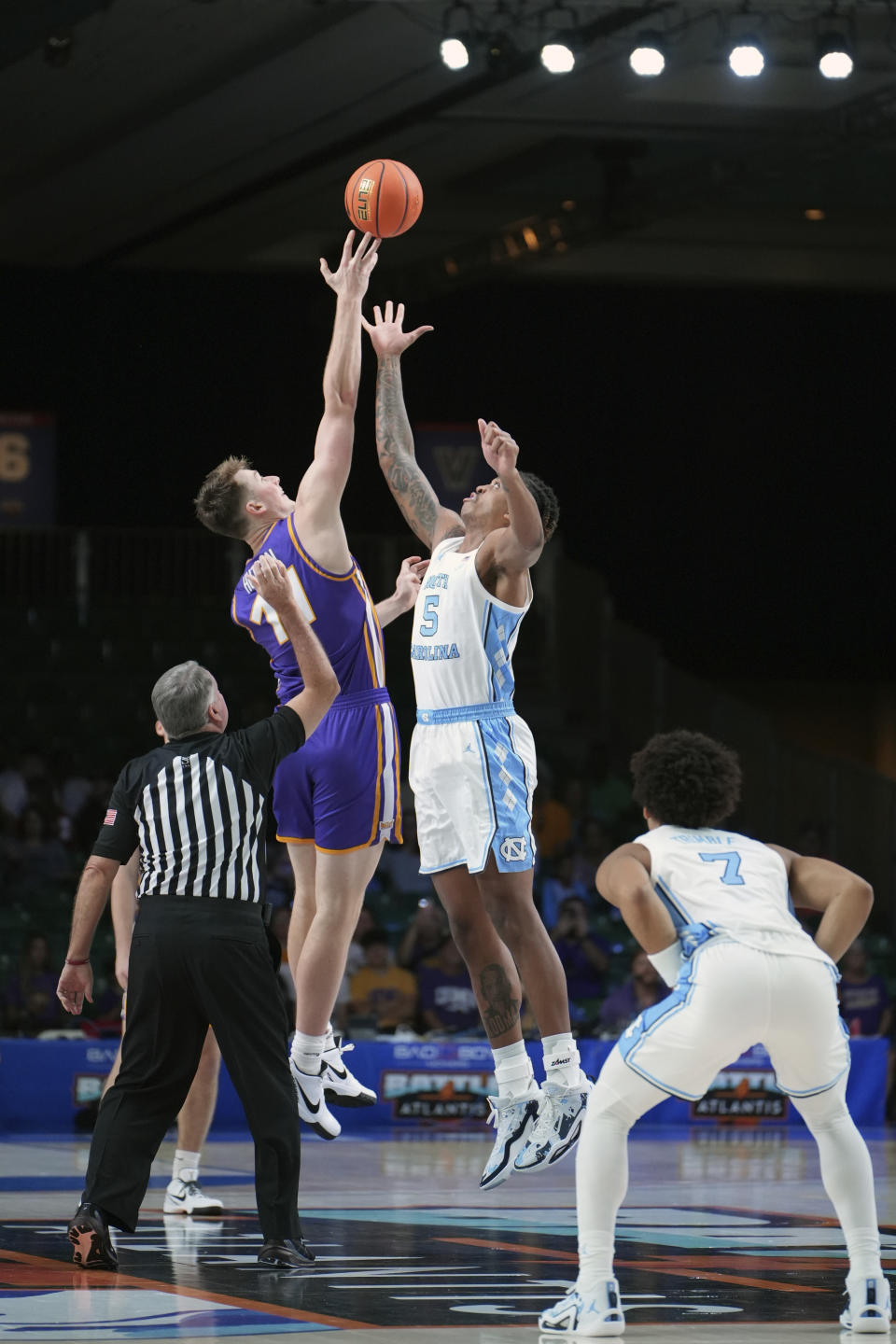 Northern Iowa's Jacob Hutson, left, and North Carolina's Armando Bacot battle for the tip off during an NCAA college basketball game in the Battle 4 Atlantis at Paradise Island, Bahamas, Wednesday, Nov. 22, 2023. (Ronnie Archer/Bahamas Visual Services via AP)