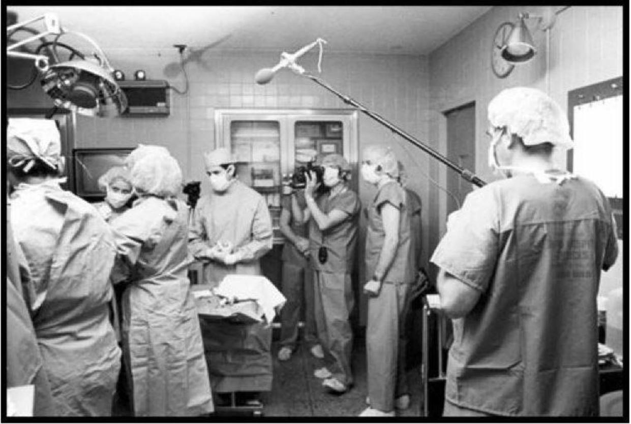 Medical providers and members of the media filming a documentary about Carr's birth stand in an operating room. (Courtesy Elizabeth Carr)
