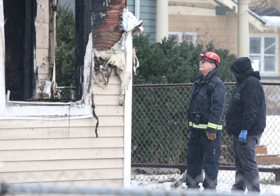 South Bend Fire Inspector Barry Sebesta, left, joins a team of fire investigators outside the house at 222 N. LaPorte Ave. Wednesday, Jan. 24, 2024, after Sunday’s fire where five children died inside the home.
