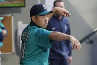 Seattle Mariners starting pitcher Yusei Kikuchi stays loose by going through pitching motions in the dugout between the fourth and fifth innings of the team's baseball game against the Tampa Bay Rays, Friday, June 18, 2021, in Seattle. (AP Photo/Ted S. Warren)