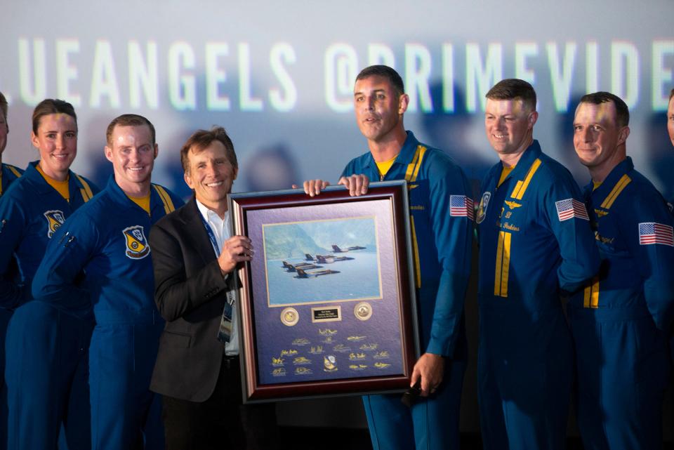 Blue Angels Commanding Officer Cmdr. Alex Armatas recognizes Rob Stone as an honorary Blue Angels before the new IMAX film "The Blue Angels" premiere at the AMC Theater on Bayou Boulevard on Thursday, May 16, 2024.