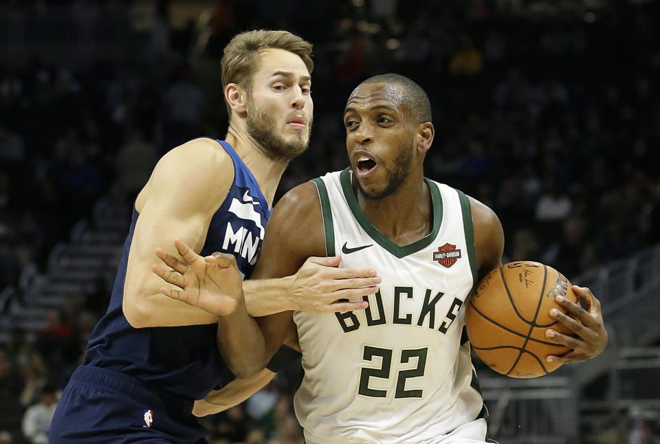 Milwaukee Bucks' Khris Middleton (22) drives to the basket against Minnesota Timberwolves' Jake Layman during the first half of a preseason NBA basketball game Thursday, Oct. 17, 2019, in Milwaukee. (AP Photo/Aaron Gash)