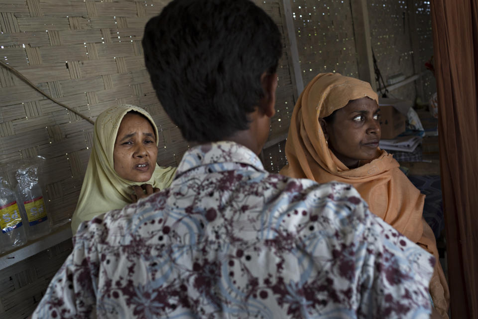 SITTWE, BURMA - MAY 06: An assitant talks to a woman about her ailments at a makeshift clinic and pharmecy in the Thet Kae Pyin refugee camp on May 6, 2014 in Sittwe, Burma. Some 150,000 Rohingya IDP (internally displaced people) are currently imprisoned in refugee camps outside of Sittwe in Rakhine State in Western Myanmar. Medecins Sans Frontieres (MSF), the primary supplier of medical care within the camps, was banned in March by the Myanmar government. Follow up attacks by Buddhist mobs on the homes of aid workers in Sittwe put an end to NGO operations in the camps. Though some NGOs are beginning to resume work, MSF remains banned, and little to no healthcare is being provided to most Rohingya IDPs. One Rohingya doctor is servicing 150,000 refugees with limited medication. Several Rakhine volunteer doctors sporadically enter the camps for two hours a day. Births are the most complicated procedures successfully carried out in the camps, requests to visit Yangon or Sittwe hospitals for life threatening situations require lengthy applications and are routinely denied. Malnutrition and diarrhea are the most widespread issues, but more serious diseases like tuberculosis are going untreated and could lead to the rise of drug resistant tuberculosis (DR-TB).  (Photo by Andre Malerba/Getty Images)