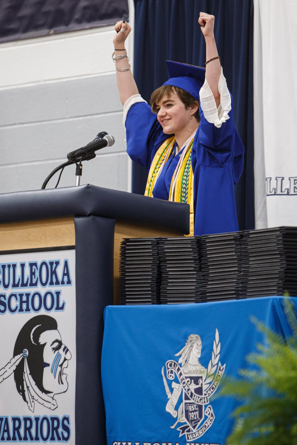 Valedictorian Calleway Schmidt throws his arms in the air in celebration during his commencement speech at the Culleoka Unit School graduation ceremony at the gymnasium in Culleoka, Tenn. on May 18, 2023.