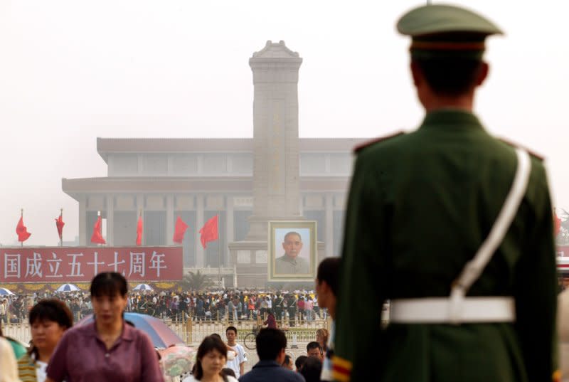 Chinese tourists walk past a Chinese soldier standing guard on Tiananmen Square in Beijing on October 1, 2006. On this day in 1989, hundreds of student-led pro-democracy demonstrators were killed and thousands wounded as Chinese troops attempted to remove them from the square. File Photo by Stephen Shaver/UPI